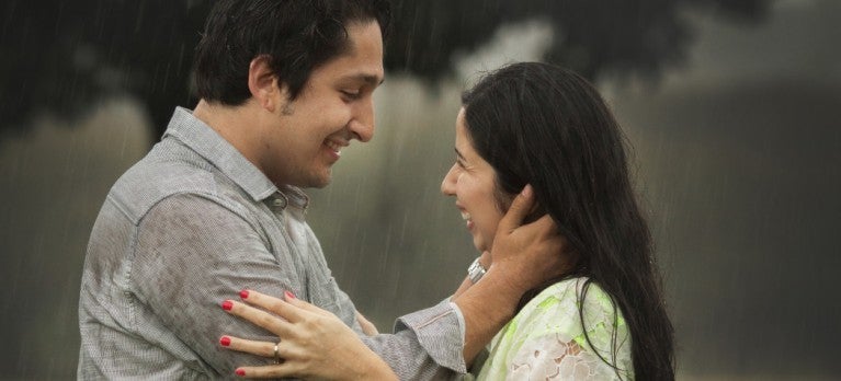 Couple in rain about to kiss